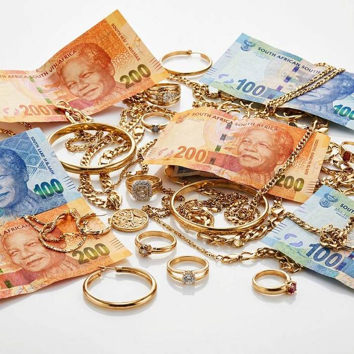 Fan of Rand notes with gold jewellery